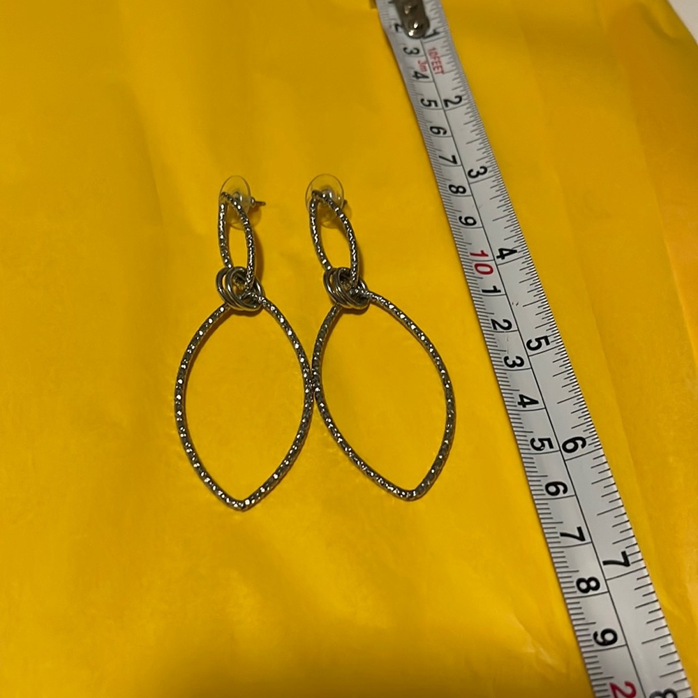 Dangle earrings. Silver in color. No markings.